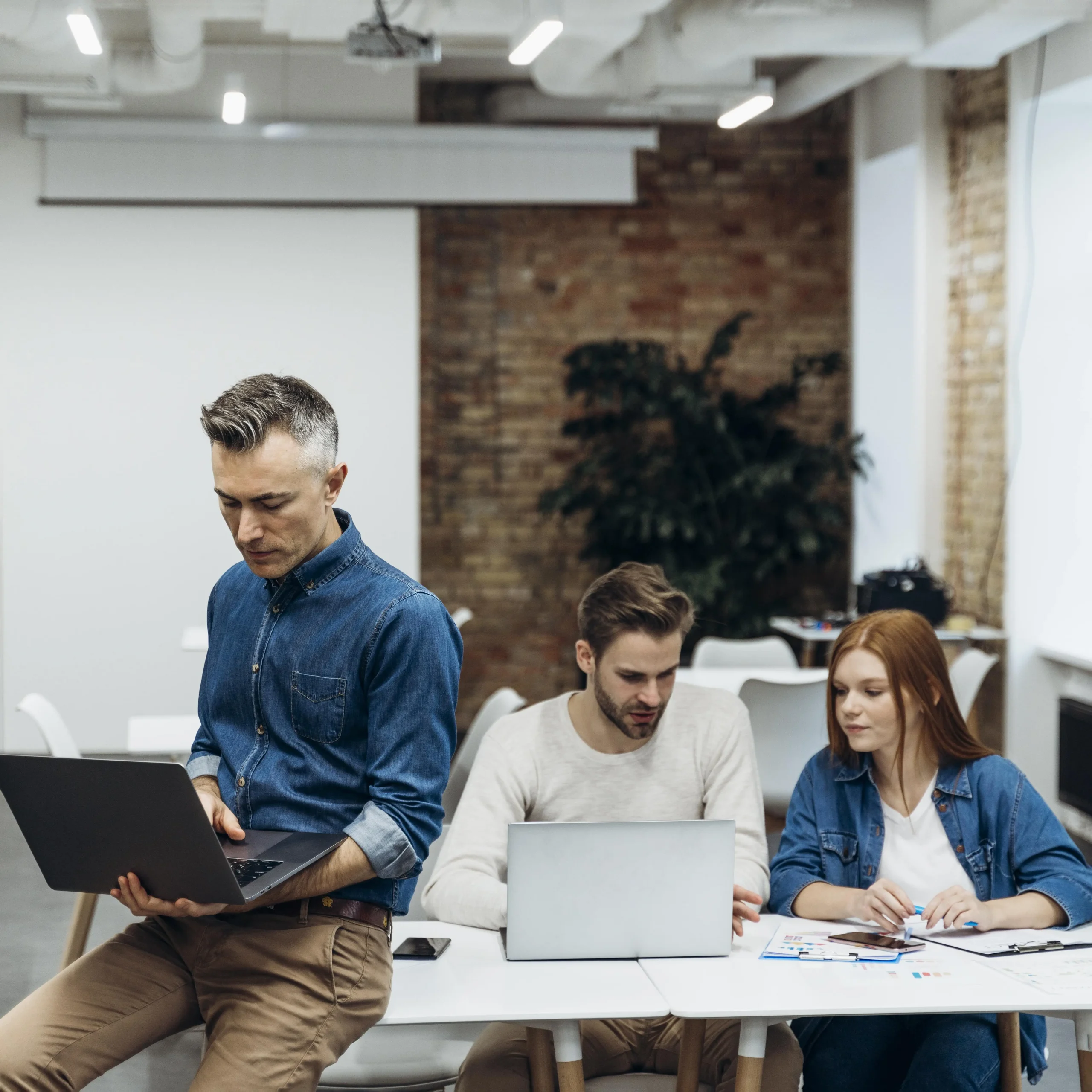 Coworkers discussing business project indoors